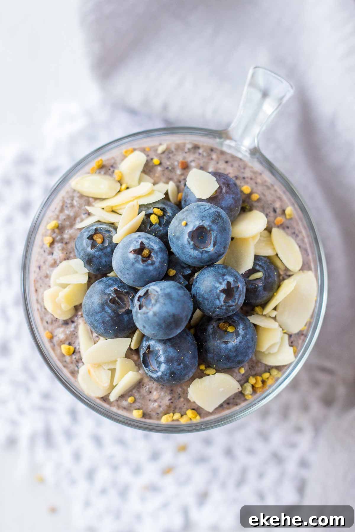 Upper view of Blueberry Chia Pudding served in a glass bowl topped with fresh blueberries