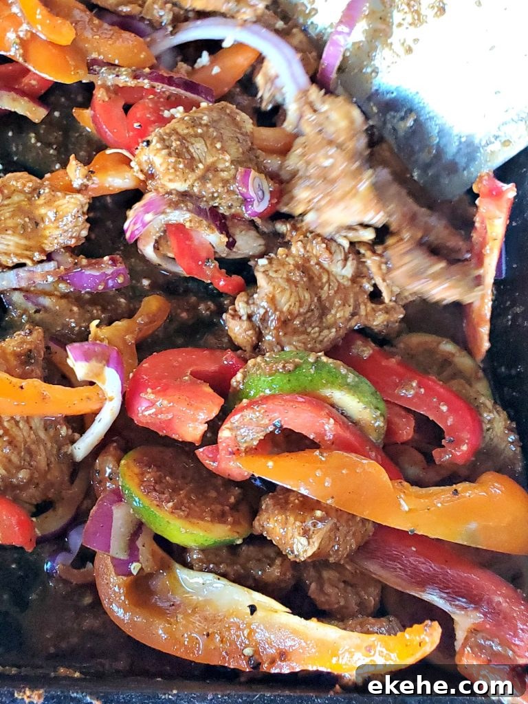 Chicken fajitas on blackstone with veggies mixed in