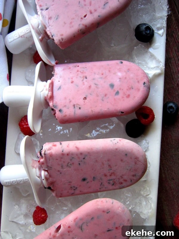 Raspberry and Blueberry Frozen Yogurt Popsicles for Summer Treats 4 Raspberry & Blueberry Frozen Yogurt Pops on a white serving platter