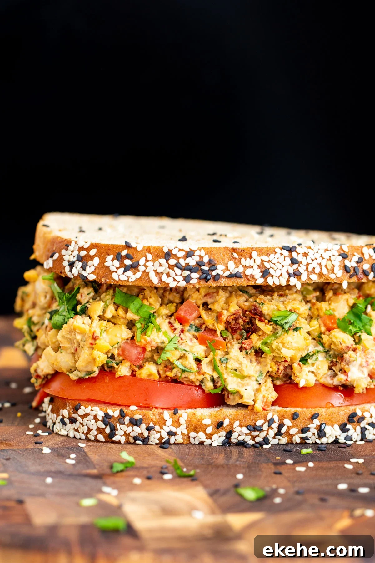 close up side view of vegan Mediterranean chickpea sandwich 