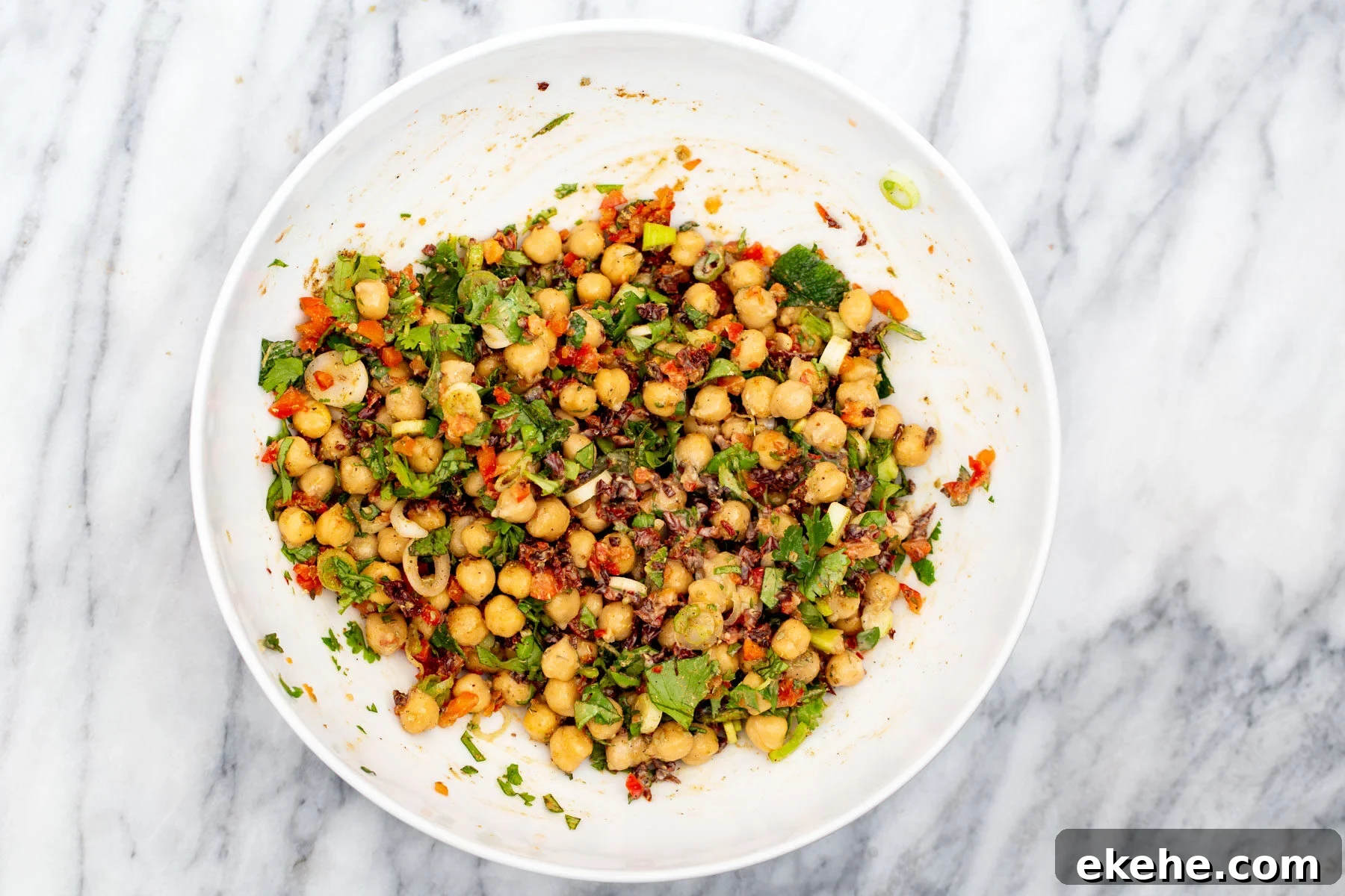 Chickpeas tossed with chopped veggies, spices and Mediterrenean herbs for chickpea salad
