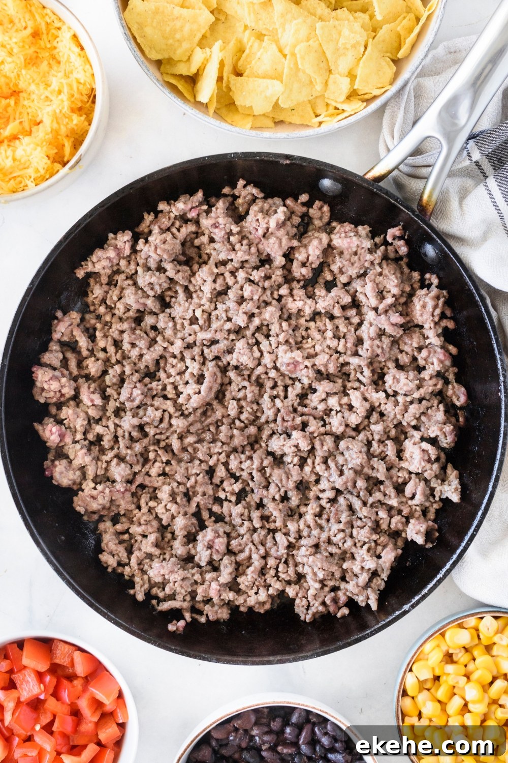A skillet filled with cooked ground beef.