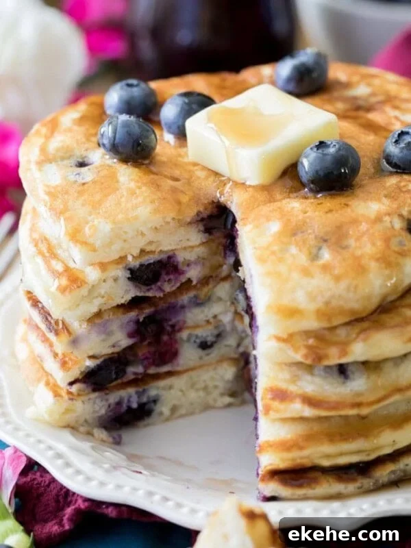 Fluffy Sourdough Pancakes Recipe for Crispy-Edge Breakfast 12 Stack of blueberry pancakes topped with pat of butter