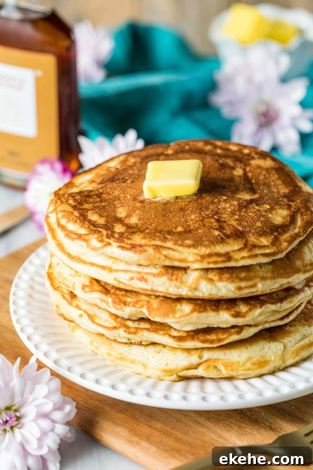 Fluffy Sourdough Pancakes Recipe for Crispy-Edge Breakfast 7 Tall stack of sourdough discard pancakes with a pat of butter on top.