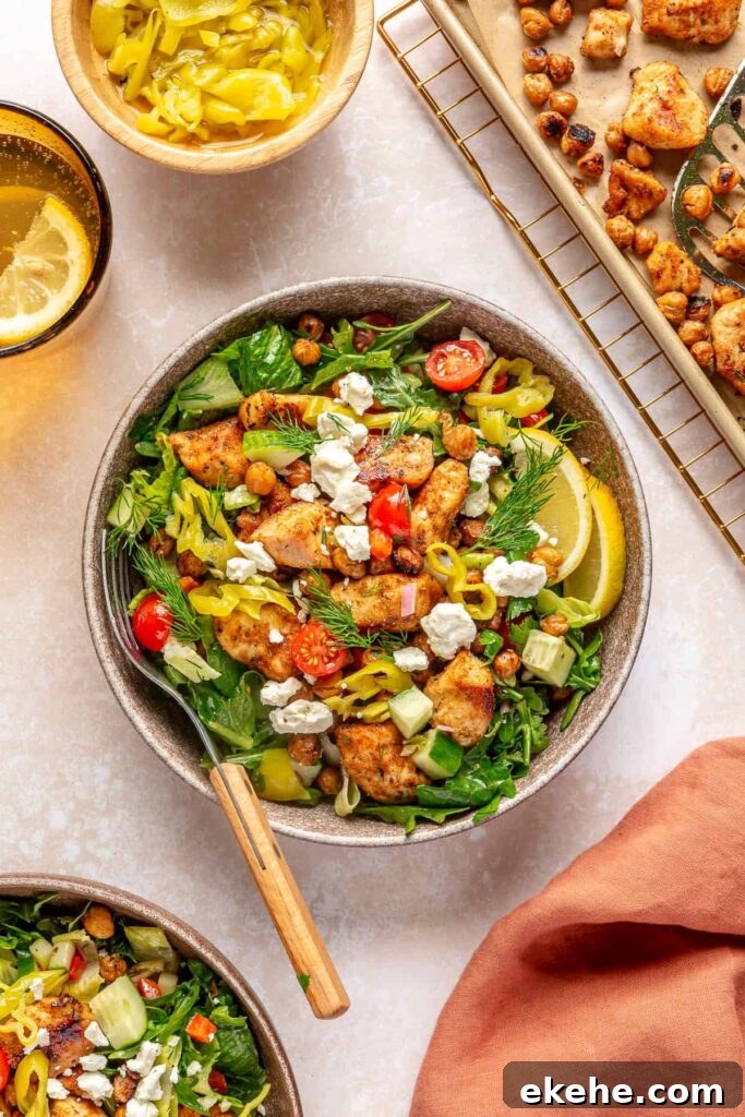 High-protein Greek chicken and chickpea salad with lemon dressing and fresh vegetables