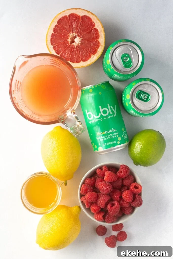 top down shot of lemons, grapefruit, limes, raspberries, juices, and cans of lime sparkling water.