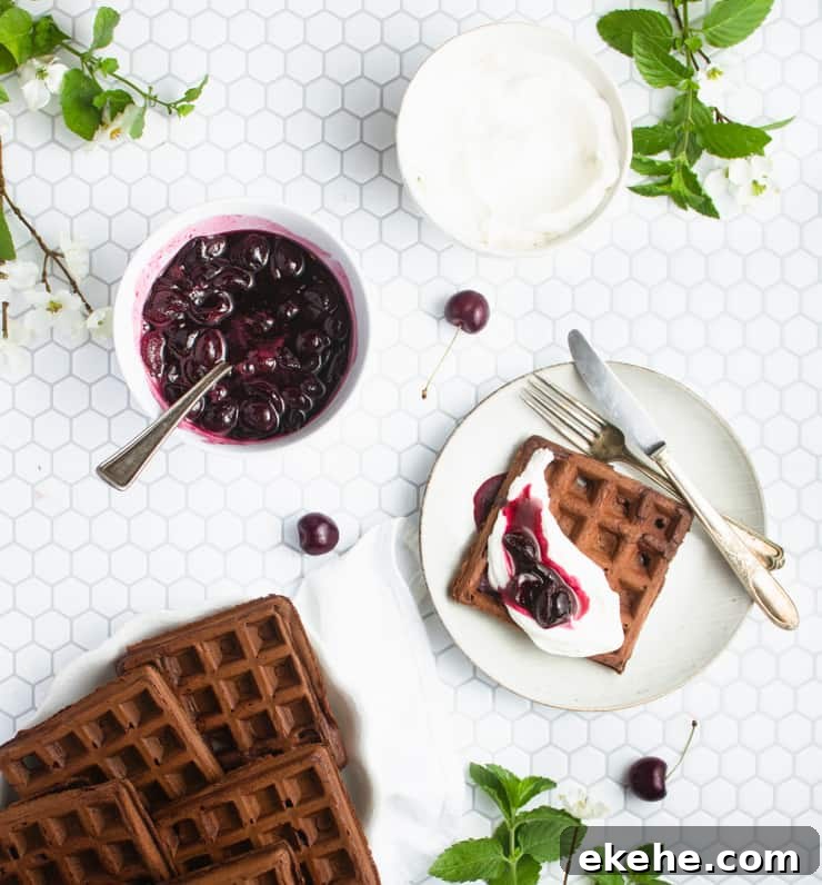 plate of chocolate waffles with a plated waffle next to it