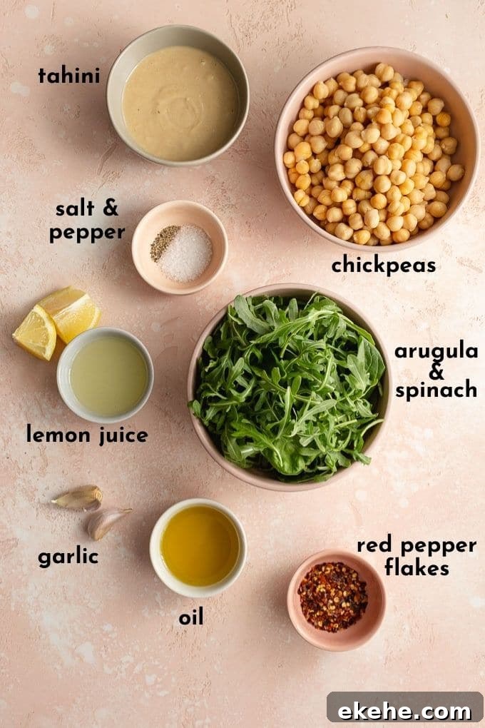 Ingredients to make arugula hummus arranged individually and labelled.